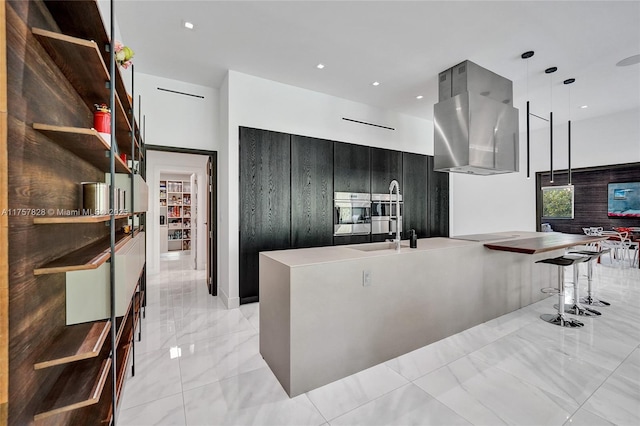 kitchen with modern cabinets, dark cabinets, marble finish floor, light countertops, and a sink