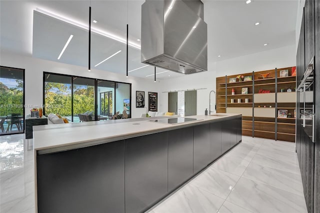 kitchen featuring modern cabinets, open floor plan, black electric stovetop, and extractor fan