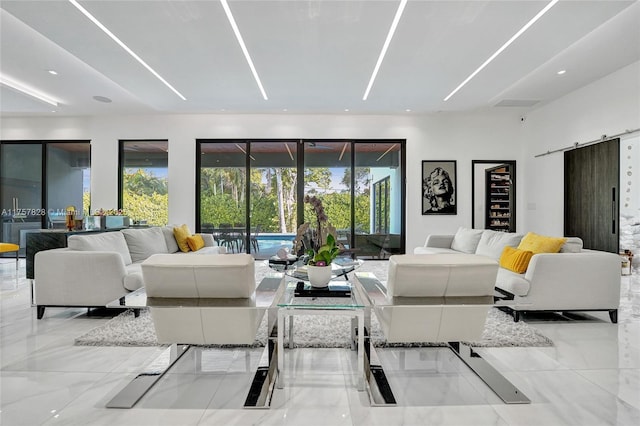 living area featuring marble finish floor and a barn door