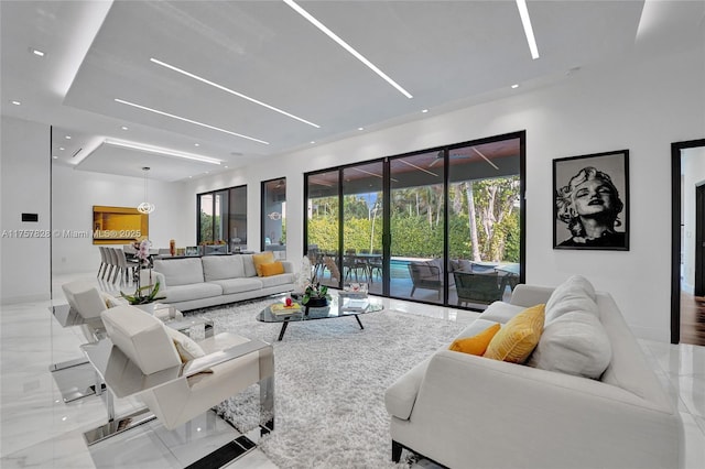 living area with marble finish floor, baseboards, and recessed lighting