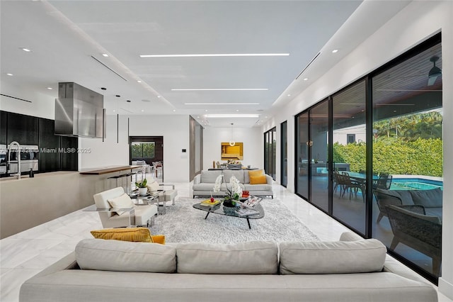 living area with recessed lighting and marble finish floor