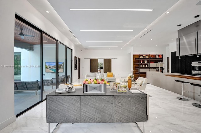 living area with marble finish floor and recessed lighting