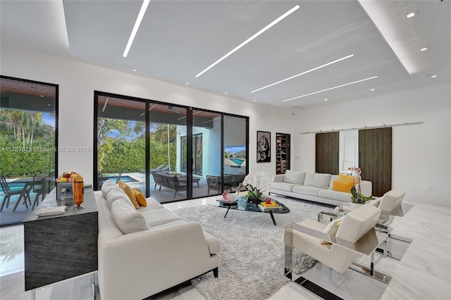 living room with recessed lighting, marble finish floor, and a barn door