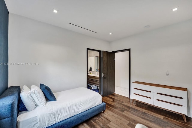 bedroom featuring wood finished floors and recessed lighting