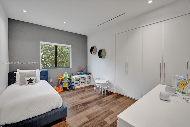 bedroom featuring wood finished floors and recessed lighting