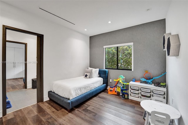 bedroom featuring wood finished floors and recessed lighting