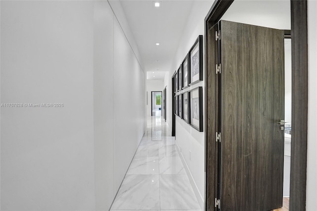 hallway featuring marble finish floor