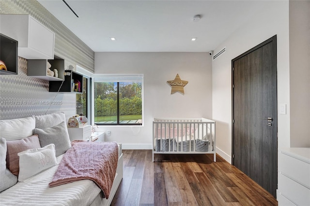 bedroom featuring baseboards and hardwood / wood-style floors