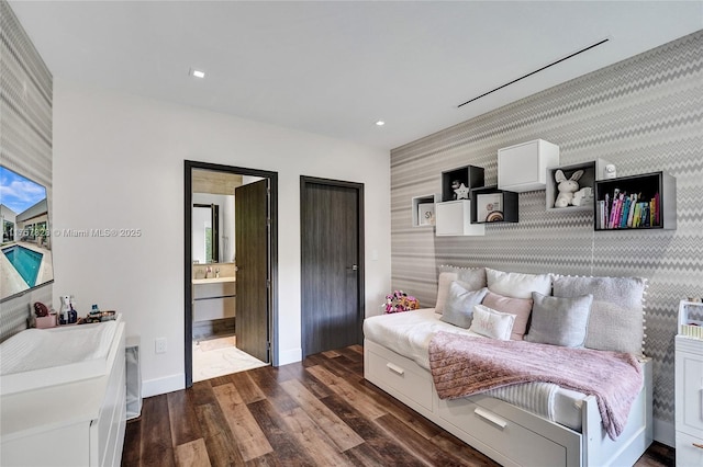 bedroom with wallpapered walls, baseboards, an accent wall, dark wood-type flooring, and recessed lighting