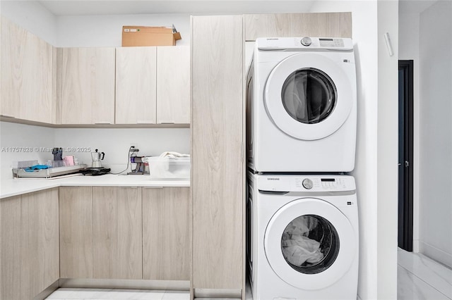 clothes washing area featuring laundry area and stacked washer and clothes dryer