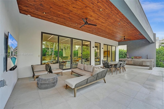 view of patio / terrace featuring outdoor dining area, ceiling fan, area for grilling, and an outdoor hangout area