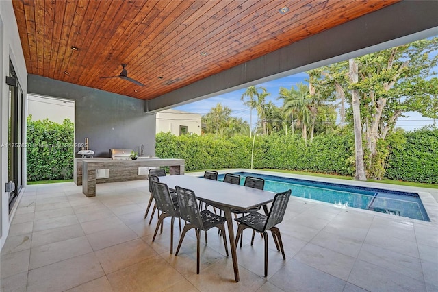 view of patio / terrace with outdoor dining area, area for grilling, a grill, ceiling fan, and an outdoor pool