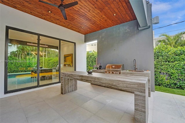 view of patio / terrace featuring a sink, area for grilling, a grill, and a ceiling fan