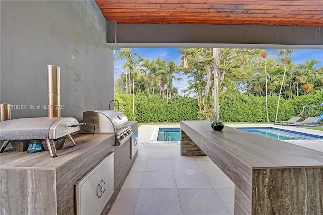 view of patio featuring area for grilling and an outdoor pool