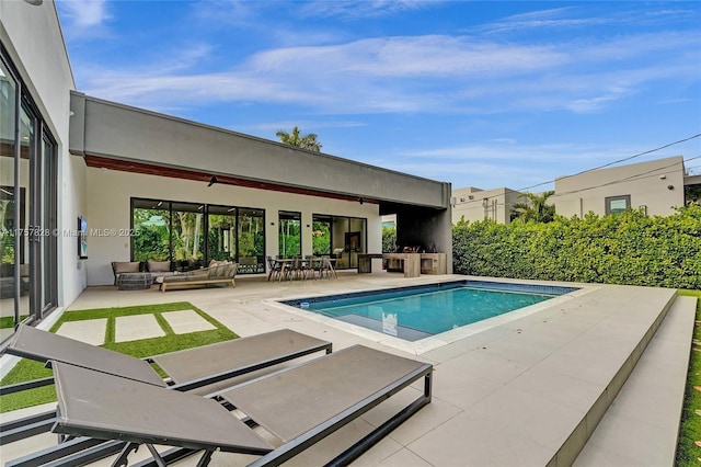 view of swimming pool with a fenced in pool, a patio area, and an outdoor living space