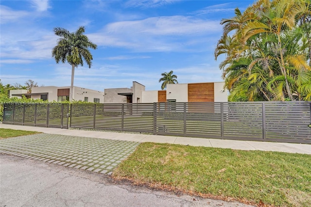 exterior space with a fenced front yard and stucco siding