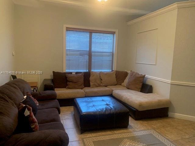 living room featuring crown molding, light tile patterned floors, and baseboards