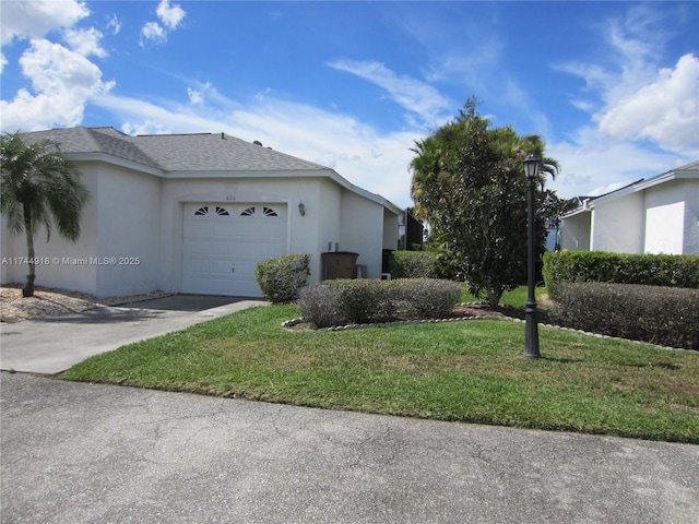 view of side of home with driveway, a lawn, an attached garage, and stucco siding