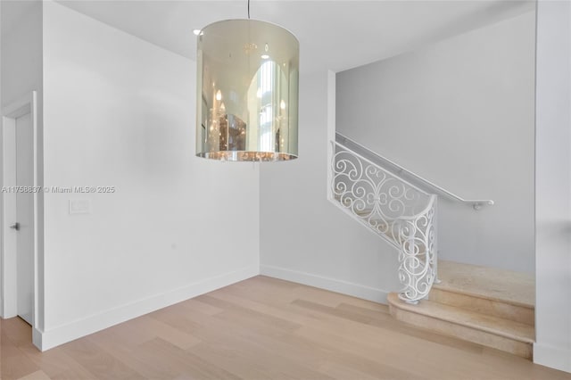 interior space with wood finished floors and baseboards