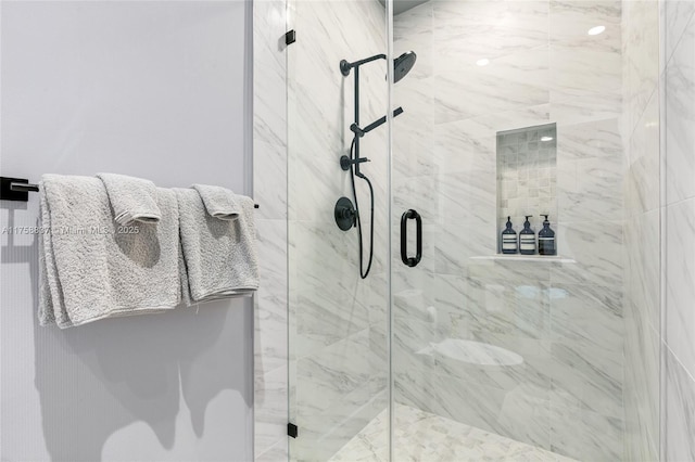 bathroom with a marble finish shower