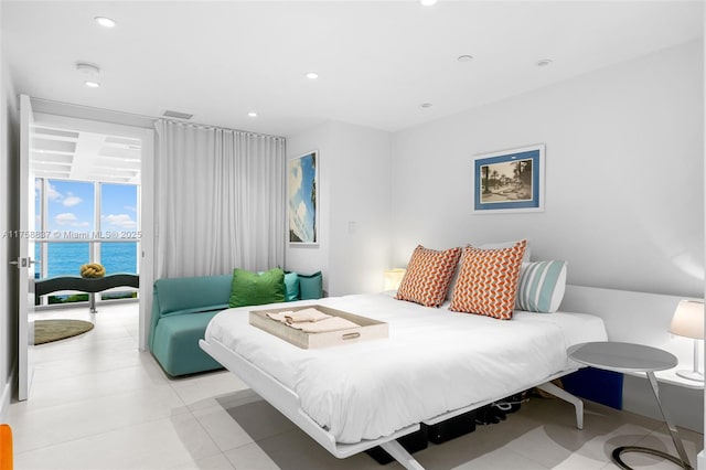 bedroom with a water view, visible vents, and recessed lighting