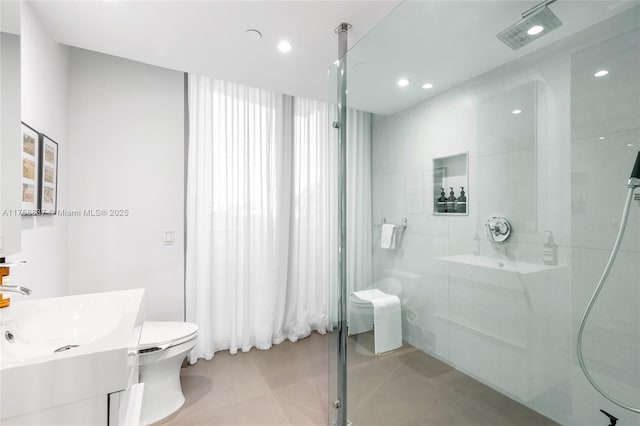 bathroom featuring toilet, tile patterned flooring, vanity, a walk in shower, and recessed lighting