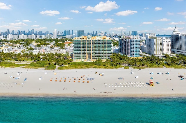 bird's eye view with a water view, a view of city, and a beach view