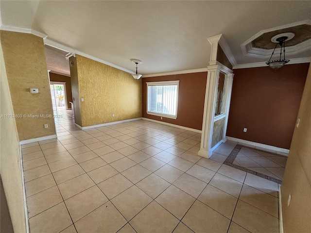 empty room featuring light tile patterned floors, baseboards, crown molding, and ornate columns