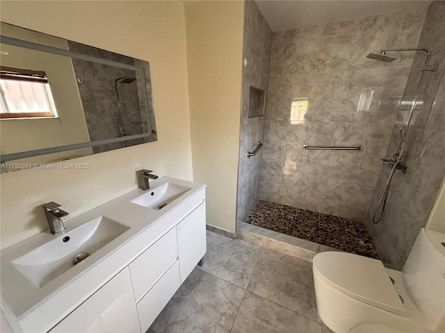 full bathroom with a sink, tiled shower, toilet, and double vanity