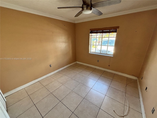 empty room featuring light tile patterned floors, baseboards, and ornamental molding