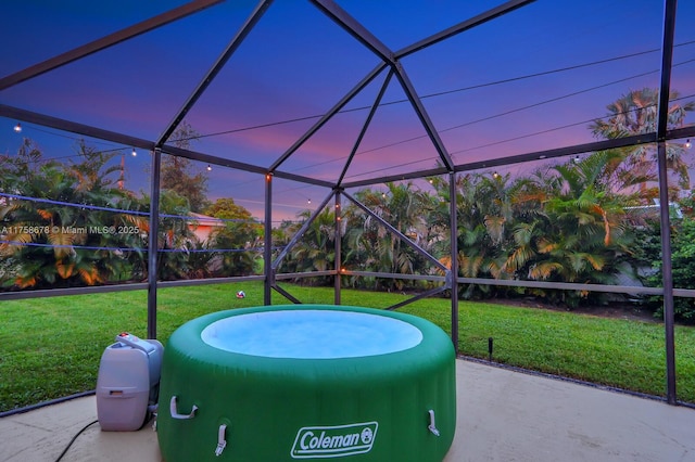 view of patio featuring glass enclosure