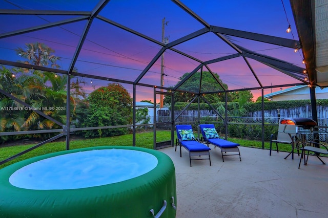 view of patio with glass enclosure and a fenced backyard