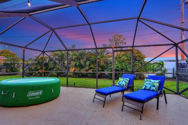 view of patio featuring glass enclosure