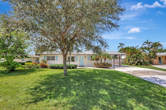 ranch-style house with an attached carport, concrete driveway, stucco siding, and a front yard