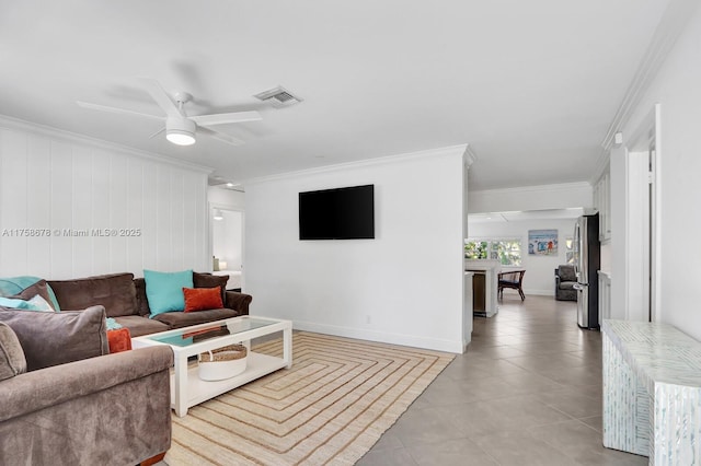 living room with light tile patterned floors, a ceiling fan, visible vents, and crown molding