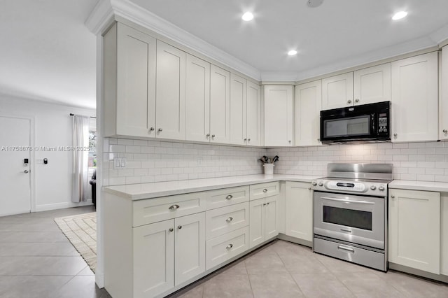 kitchen with black microwave, electric stove, light tile patterned floors, and light countertops