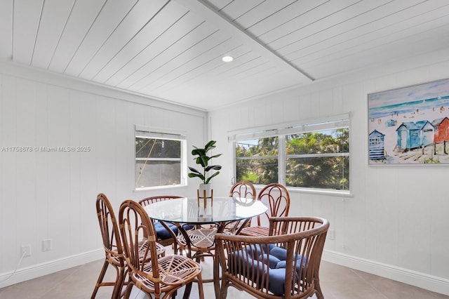 dining room featuring baseboards and light tile patterned floors