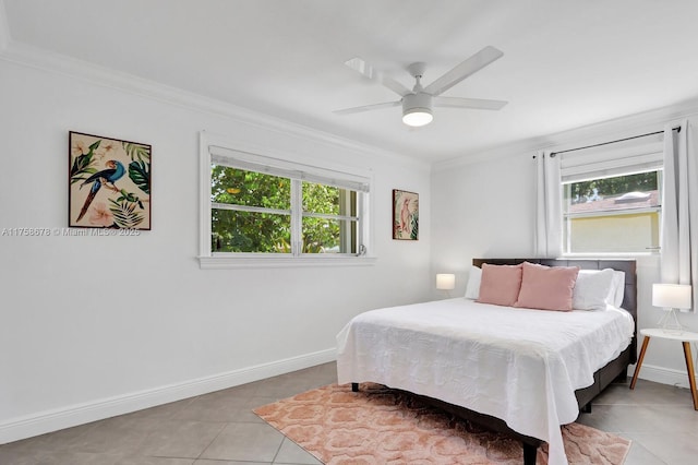 bedroom featuring multiple windows, baseboards, and crown molding