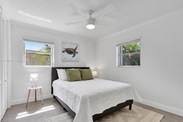 tiled bedroom featuring baseboards, ornamental molding, and a ceiling fan