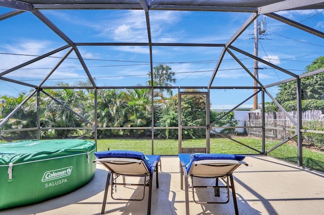 view of patio featuring glass enclosure