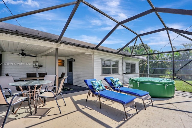 view of patio with ceiling fan, outdoor dining space, and a lanai