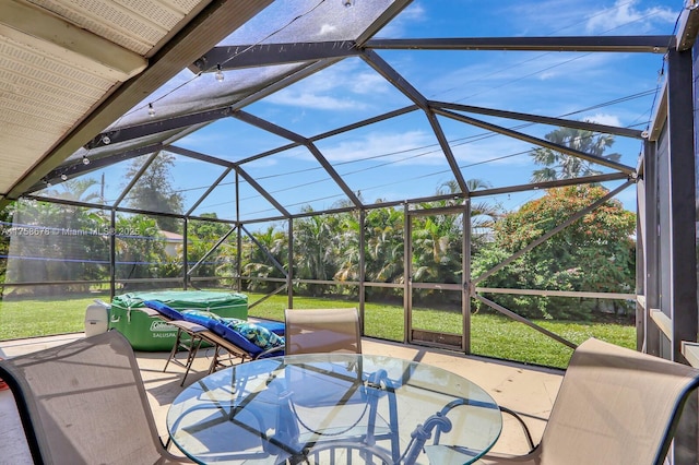 view of patio / terrace with outdoor dining area and glass enclosure