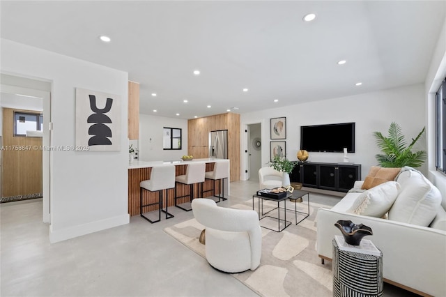 living area featuring recessed lighting and finished concrete flooring