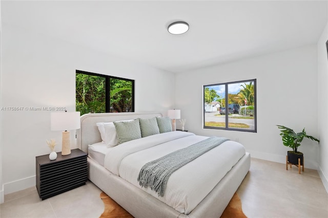 bedroom with multiple windows and baseboards