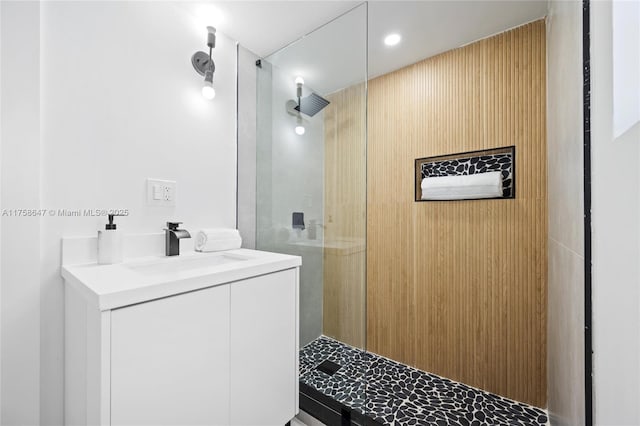 full bathroom with a walk in shower and vanity