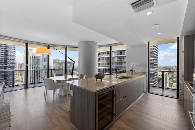 kitchen with wine cooler, visible vents, and floor to ceiling windows