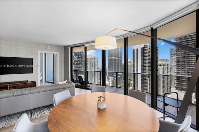 dining space with a view of city and expansive windows