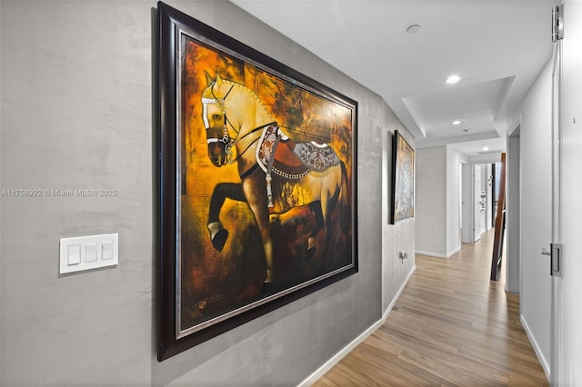 corridor featuring recessed lighting, wood finished floors, and baseboards