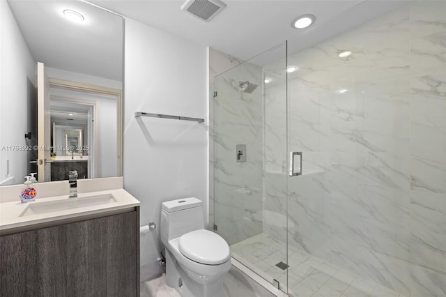 full bath featuring a marble finish shower, visible vents, toilet, marble finish floor, and vanity