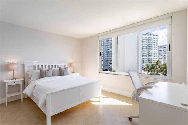 bedroom with a view of city and baseboards